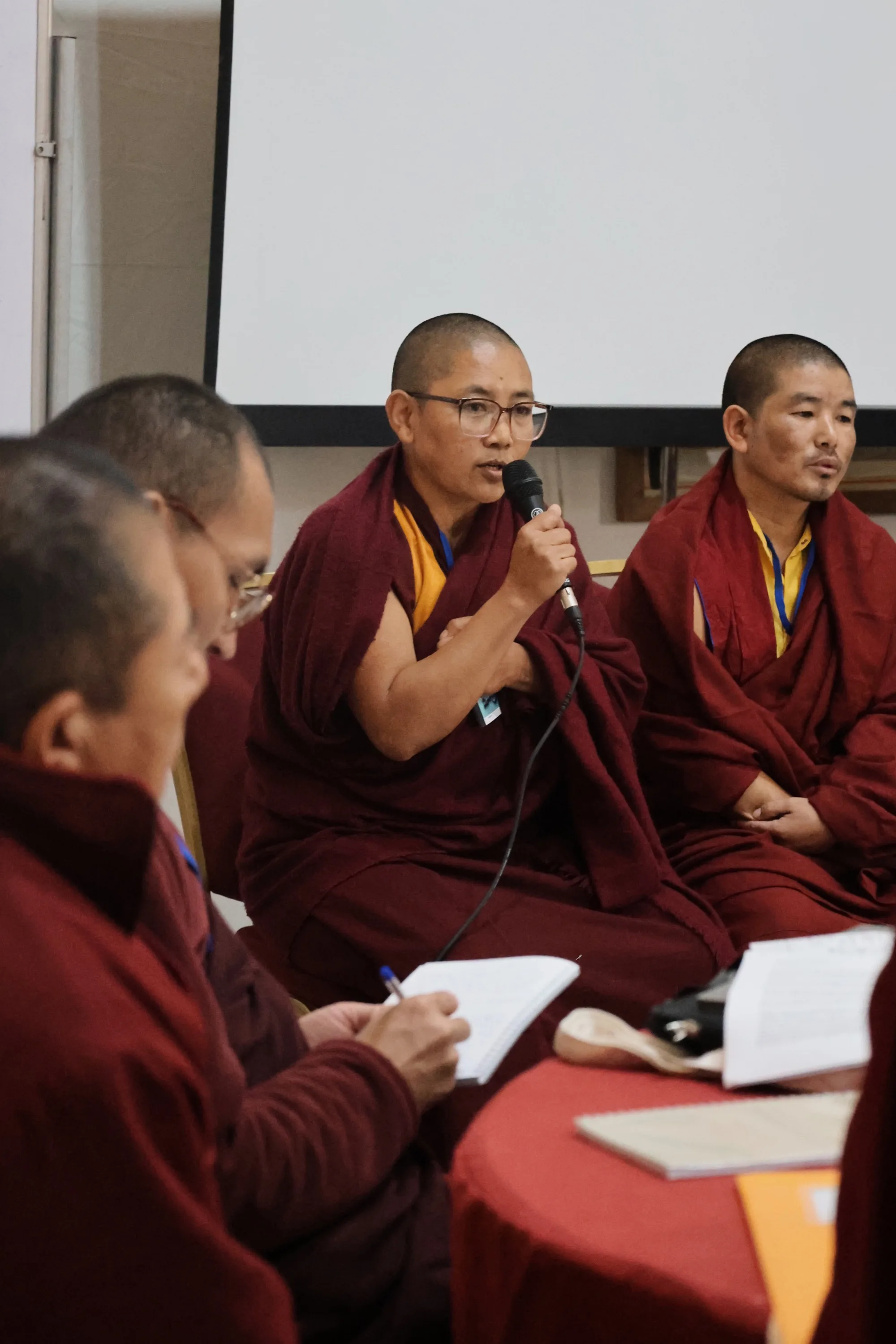 Monastic educator sharing experiences during a panel discussion